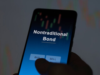 An investor analyzing the nontraditional bond etf fund on a screen. A phone shows the prices of Nontraditional Bond