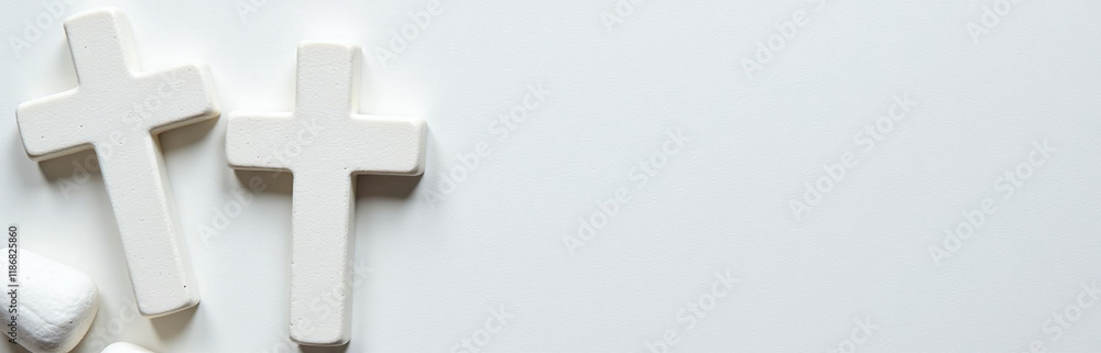 Poster a white stone cross is placed atop a textured background made of similar white stones in an elegant 