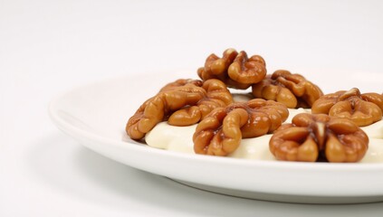 Caramelized walnuts served on a white platter sweet  crunchy