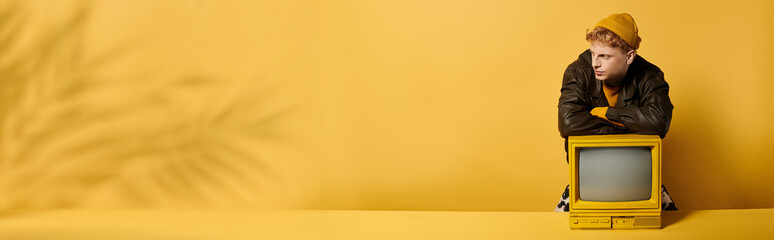 A fashionable young redhead man poses confidently in a trendy winter outfit with a vintage...