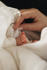 Newborn baby's legs with mother's hand. mothers day.High quality photo