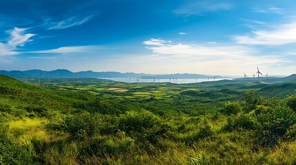 Fototapeta premium Scenic Coastal Landscape with Wind Turbines and Lush Green Hills
