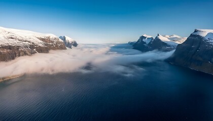 Obraz premium Aerial View Dramatic Snow Capped Mountains Misty Fjord Ocean Panorama