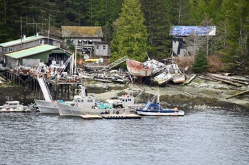 






















two commercial fishing boats are tied to a dock surrounded by the damage left by a major wind storm in 2021