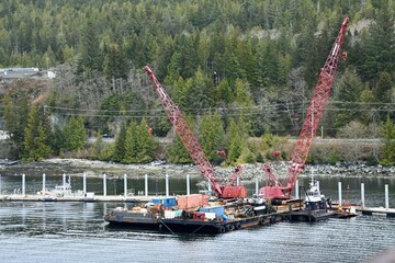 Two barges with cranes hit idle at a dock in Ketchikan, Alaska