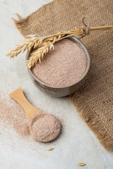 Wheat bran, rye bran in a bowl, in a wooden spatula on a light background. Healthy eating, supplements.