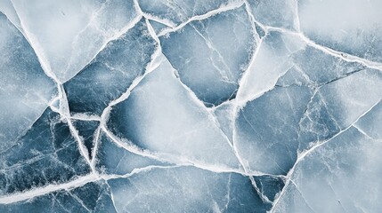 Obraz premium Ice surface with intricate cracks and patterns in a frozen landscape showcasing winter's beauty and fragility