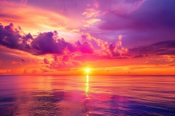 Obraz premium A vibrant sunset over calm waters, showcasing a blend of purple, pink, and orange hues.