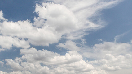Clear blue sky with fluffy white clouds