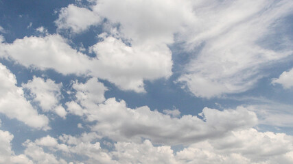 Clear blue sky with fluffy white clouds
