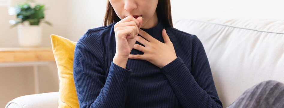 asian young woman coughing  and feeling chest pain.