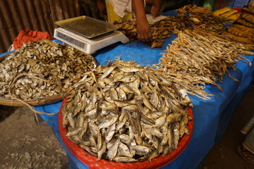 Mixed dried fish are displayed and sold at a fish market, Different types of dried fish are sold by...