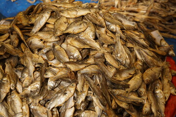 Mixed dried fish are displayed and sold at a fish market, Different types of dried fish are sold by a street vendor, All types of dried salted fish in the Asian biggest seafood market