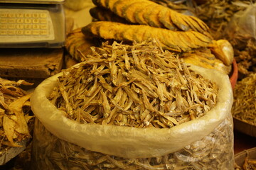 Mixed dried fish are displayed and sold at a fish market, Different types of dried fish are sold by...