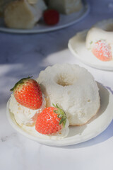 angel food cake light and fluffy sponge cake made with egg whites served with whipped cream and strawberry.