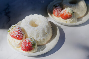 angel food cake light and fluffy sponge cake made with egg whites served with whipped cream and strawberry.