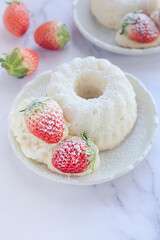 angel food cake light and fluffy sponge cake made with egg whites served with whipped cream and strawberry.