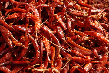 A heap of dry red chili pepper is displayed in a spice market, Dried spicy red chilies are on sale, Showcase of spicy red chili in a spice shop in Asia for the spice trade