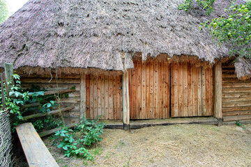 Rustic charm of an ancient thatched roof cottage nestled in a lush green landscape
