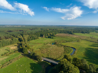 Aerial viev rural landscape and Ina river near Puszcza Goleniowska in West Pomerania, region of Poland. Photo from the drone.	
