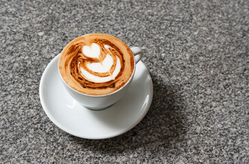 A barista prepares a latte at a professional espresso machine in a cozy coffee shop. The scene captures the meticulous process of brewing coffee, with various barista tools.