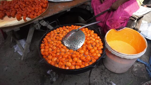 Fresh gulab jamun are being sold in a village fair, Making of Gulab Jamun in street side, delicious indian sweet gulab jamun 