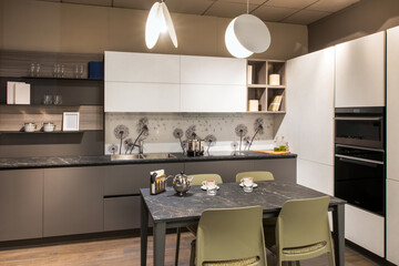 Fototapeta premium Modern gray and white kitchen interior featuring stylish dandelion backsplash and elegant pendant lamps