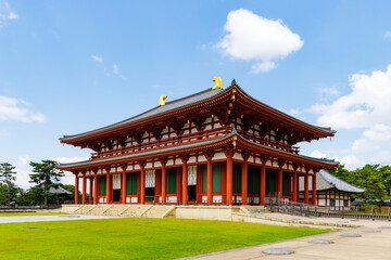 Kofuku-ji Temple in Nara, Japan with Vibrant Red and Gold Architecture under a Bright Blue Sky