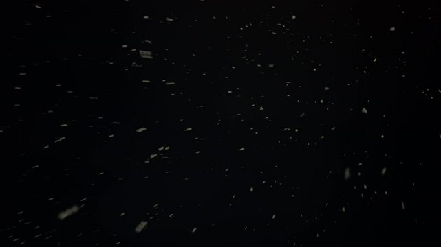 White snowflakes falling on dark background. Gentle mesmerizing snowfall in motion. Snow slowly falling down. Winter abstract snowy background. Slow, charming snowfall. Magic natural blizzard. Nobody