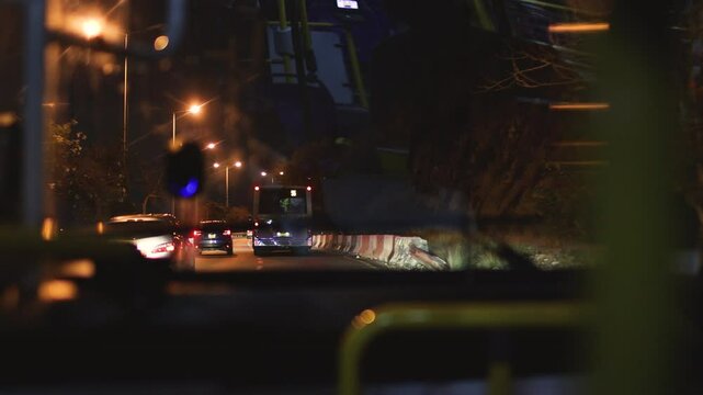 view from the bus window of the night city and road. public transport, night in the city.