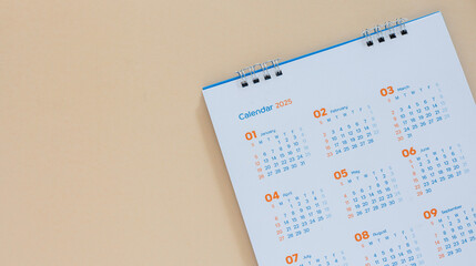 close up top view on white calendar 2025 month schedule to make appointment meeting or manage timetable each day lay on beige background for planning work and life concept