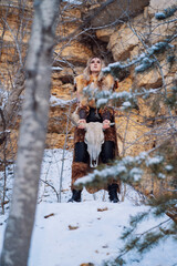 Woman in medieval warrior clothes at a quarry in winter