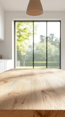 Obraz premium Sunlight illuminates an empty wooden table in a modern kitchen, creating a warm and inviting space with a blurred view of a lush garden through large windows