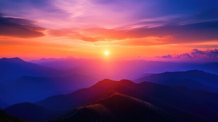 Obraz premium Breathtaking sunset over mountain ranges creating a serene atmosphere with vibrant colors and dramatic skies at dusk.