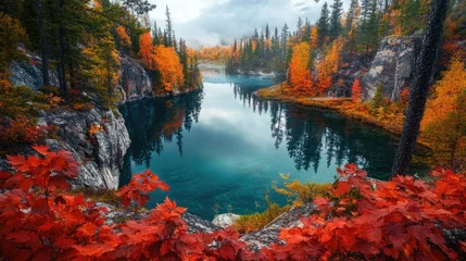 Gardinen Stunning autumn landscape featuring vibrant foliage reflecting on a tranquil lake amidst serene mountains and a cloudy sky © ArtificialHorizons