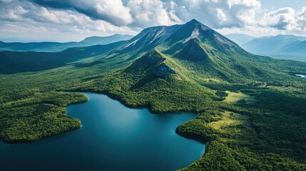 Stunning Aerial Perspective of Majestic Mountain Surrounded by Lush Green Forests and Serene Lakes under a Cloudy Sky