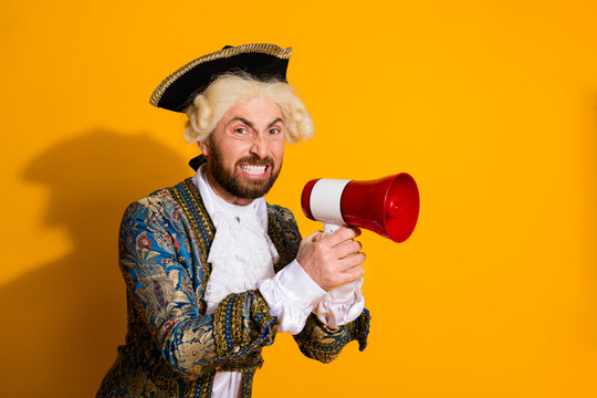 Man in an 18th-century costume shouting into a megaphone on a yellow background