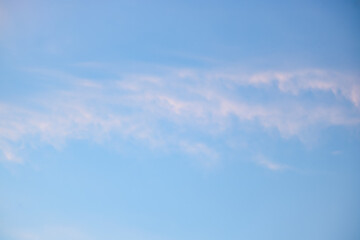 A beautiful sky tinted by the sun leaving vibrant shades of gold, pink, blue and multicolored. Clouds in the twilight evening and morning sky. Cloudy sky background in the evening, and during the day.