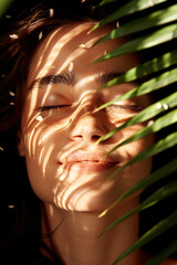 Woman with rainbow light across face, eyes closed, surrounded by lush green nature