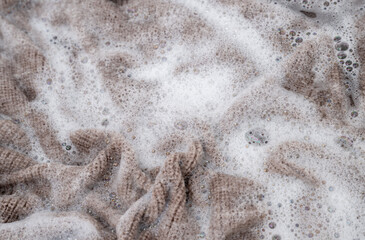 Close up of Light Colored Fine Merino Wool Sweater being Soaked in Delicate Wash 
