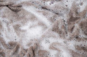 Close up of Light Colored Fine Merino Wool Sweater being Soaked in Delicate Wash 