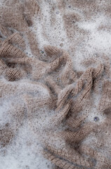 Close up of Light Colored Fine Merino Wool Sweater being Soaked in Delicate Wash 