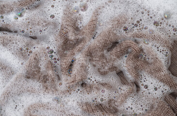 Close up of Light Colored Fine Merino Wool Sweater being Soaked in Delicate Wash 