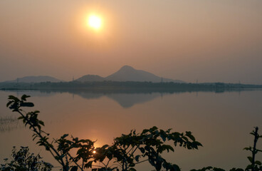 sun sets over Muradi hill in Baranti (or Barhanti) village, Purulia district. Reflection of the hill in calm waters of Baranti lake created a picturesque nature canvas in dawn.