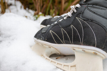 Vintage men's ice skates on snow. Close up