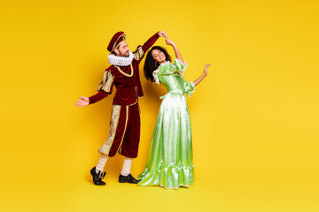 Fototapeta premium Couple in Elegant Retro Costumes Posing on Yellow Background in Theme Party Style