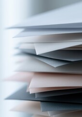 A stack of white and gray papers with a blue one on top