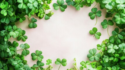 Green shamrocks form a lovely border around a light pink background