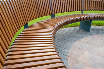 Bench for rest. A long, semicircular bench in the park.