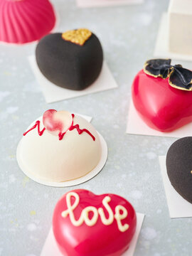 Deliciously Crafted Modern Heart-Shaped Desserts Displayed on a Light-Colored Surface for a Special Occasion
